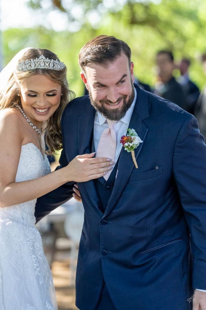 bride and broom smiling.
