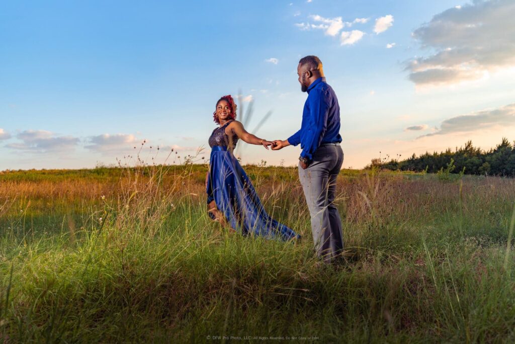 Couple in a field close to sunset.