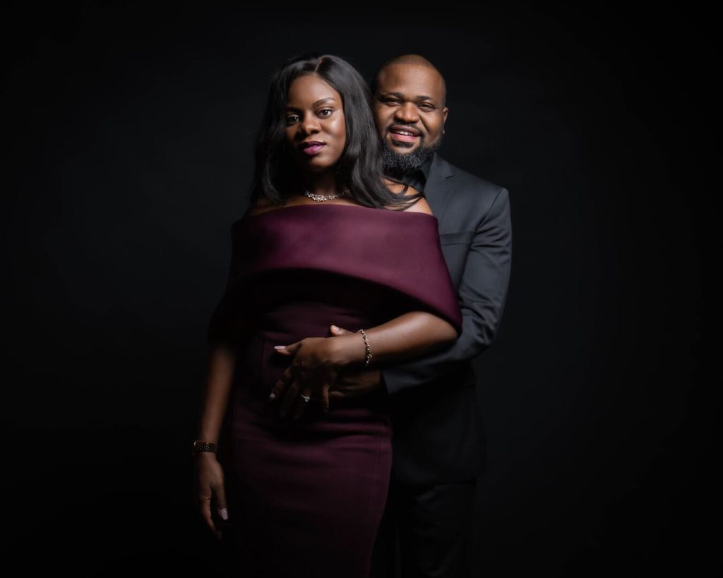Couple posing for photo in studio.