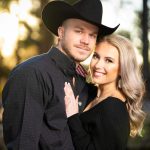 Couple posing for portrait outside.