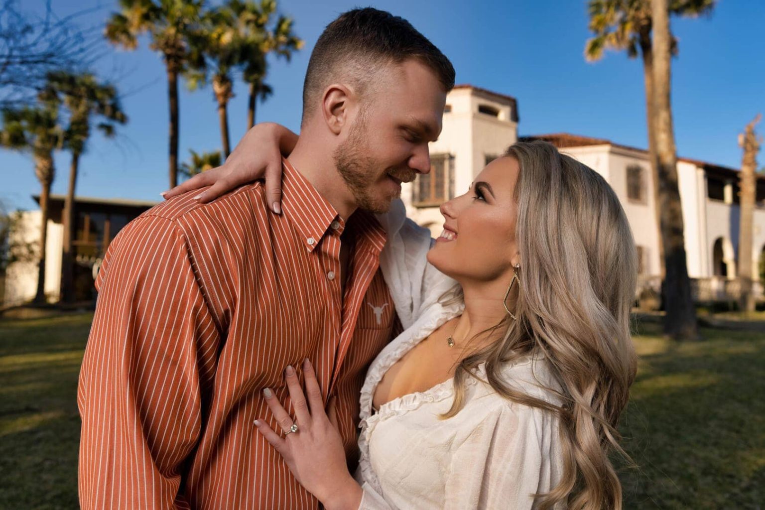 Couple posing for photo at sunset.