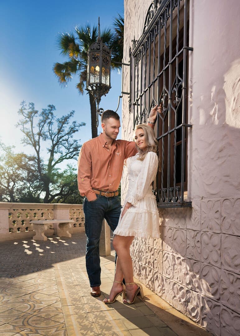 Couple posing for photo in Spanish setting.