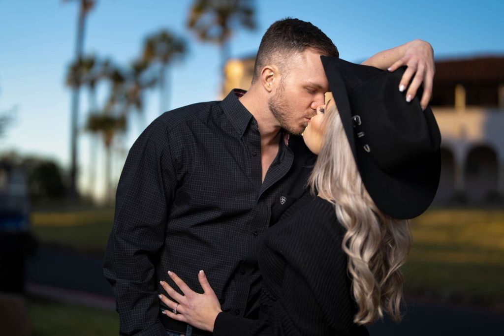 Couple posing for photo at sunset.