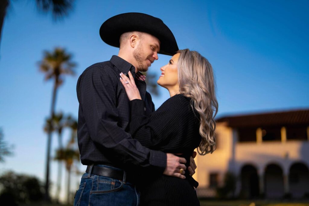 Couple posing for photo at sunset.