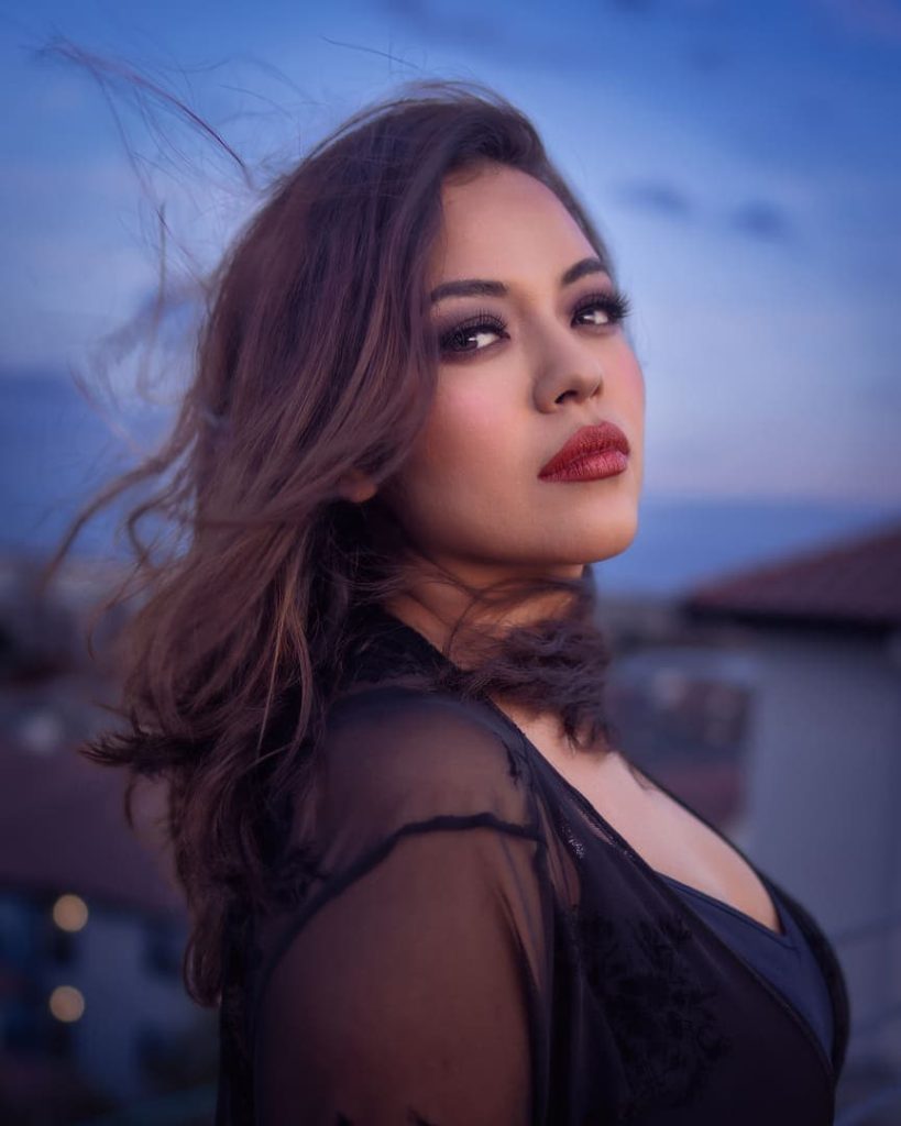Model with hair blowing in wind. Outside at blue hour.