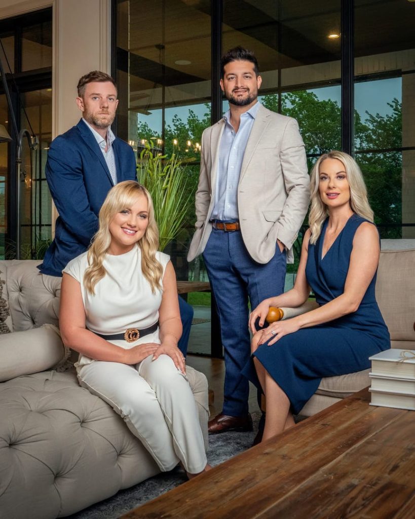 Four people sitting in living room posing for photo.