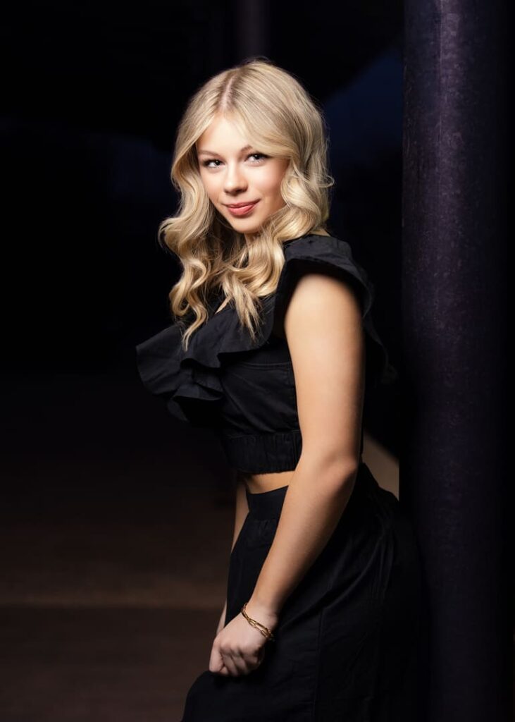 Girl in black posing for portrait.