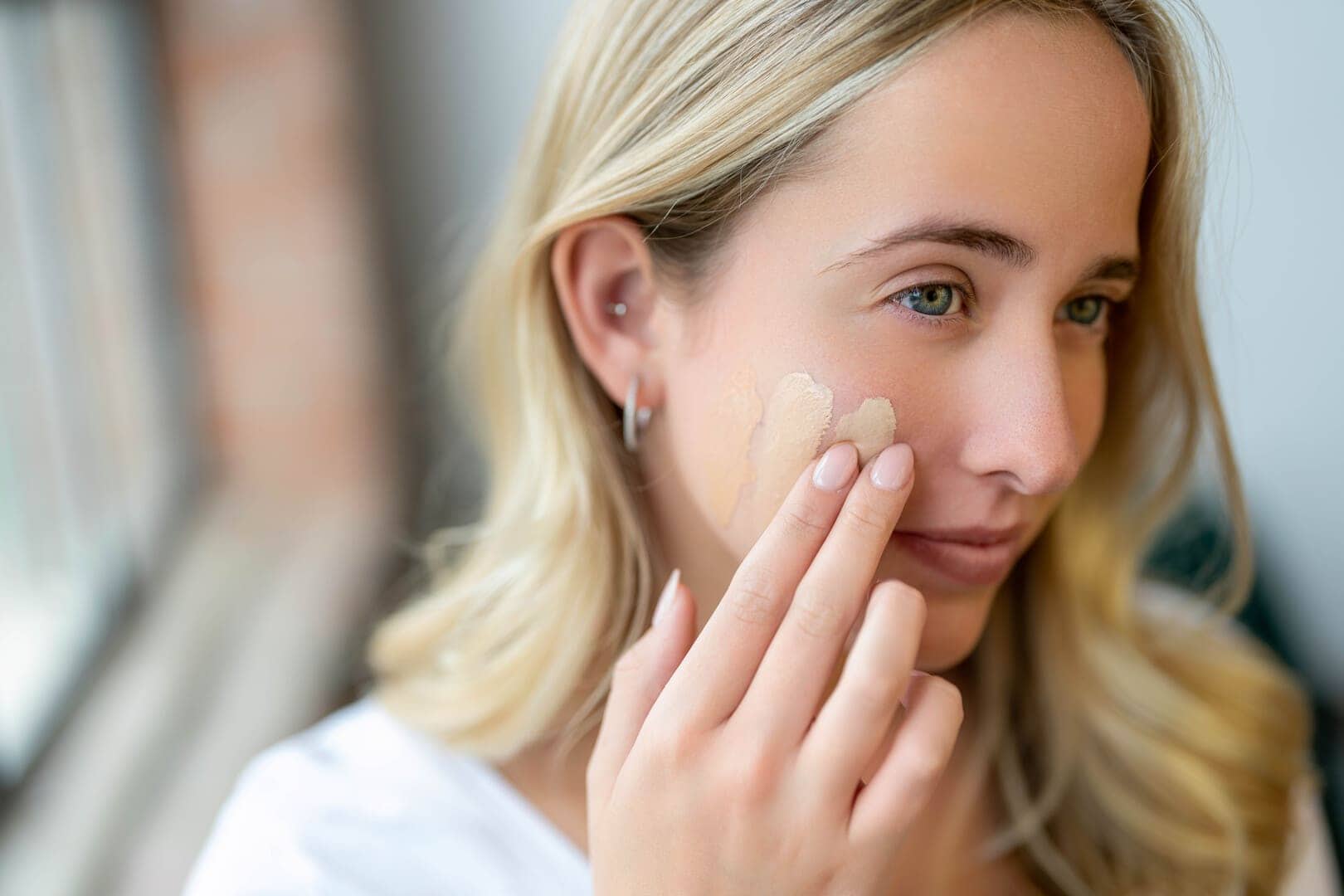 Girl applying foundation.