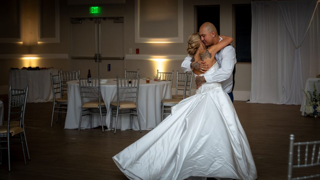 Bride and grooms, last dance. In an empty ballroom.
