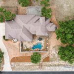Aerial drone photo of a Texas Hill-country home. Shot directly overhead looking down.