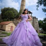 A young girl in a large purple dress for her quince.