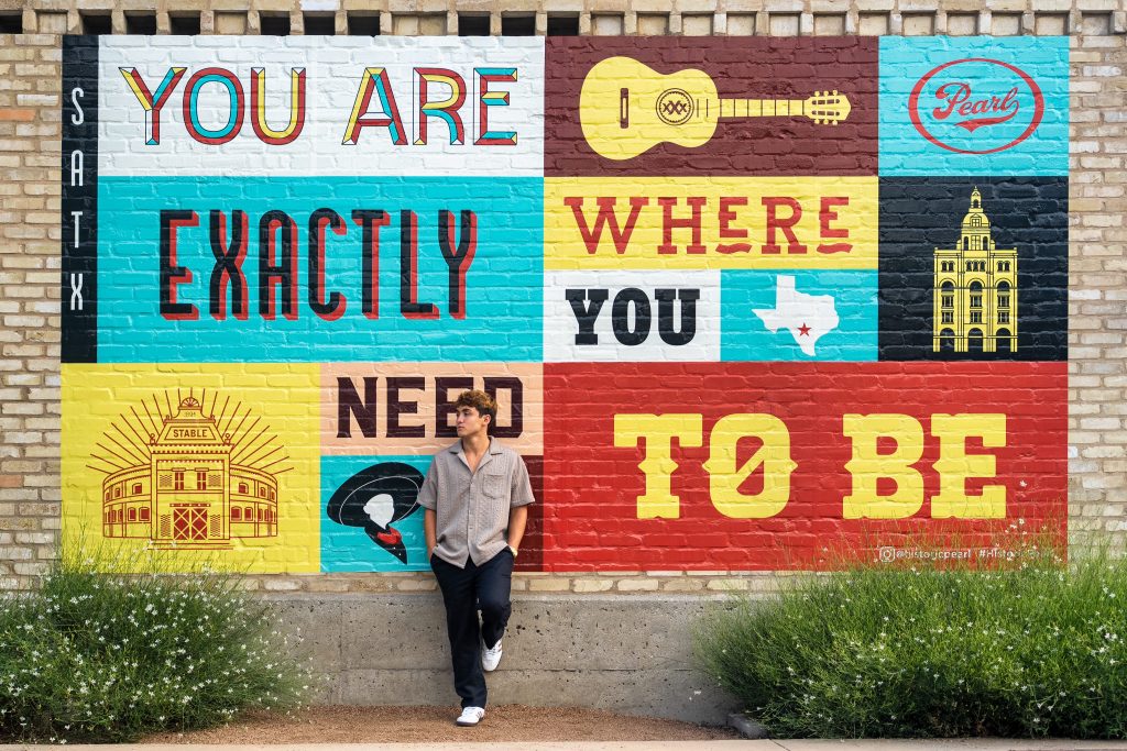 You man posing for senior photos in The Pearl District in San Antonio.