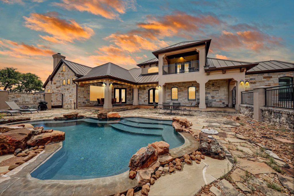 Home exterior. Courtyard with a pool. Shot at sunset.