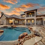 Home exterior. Courtyard with a pool. Shot at sunset.