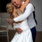 Wedding couple dancing and laughing.