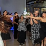 Bride throwing the bouquet to girls.