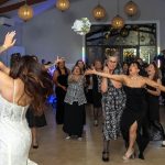Bride throwing the bouquet to girls.
