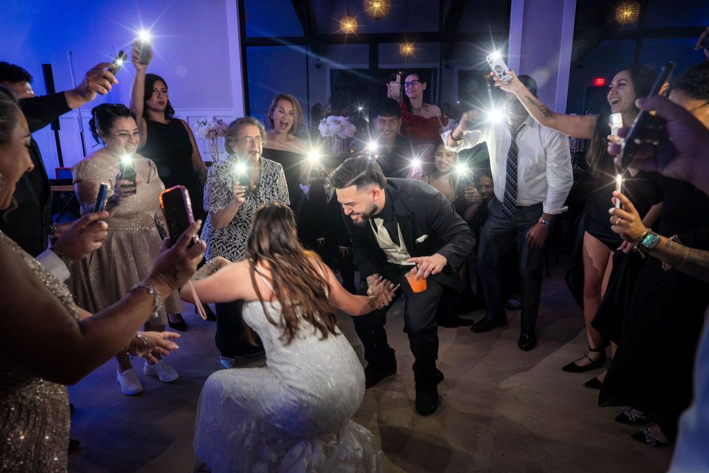 Wedding couple dancing in camera flashes
