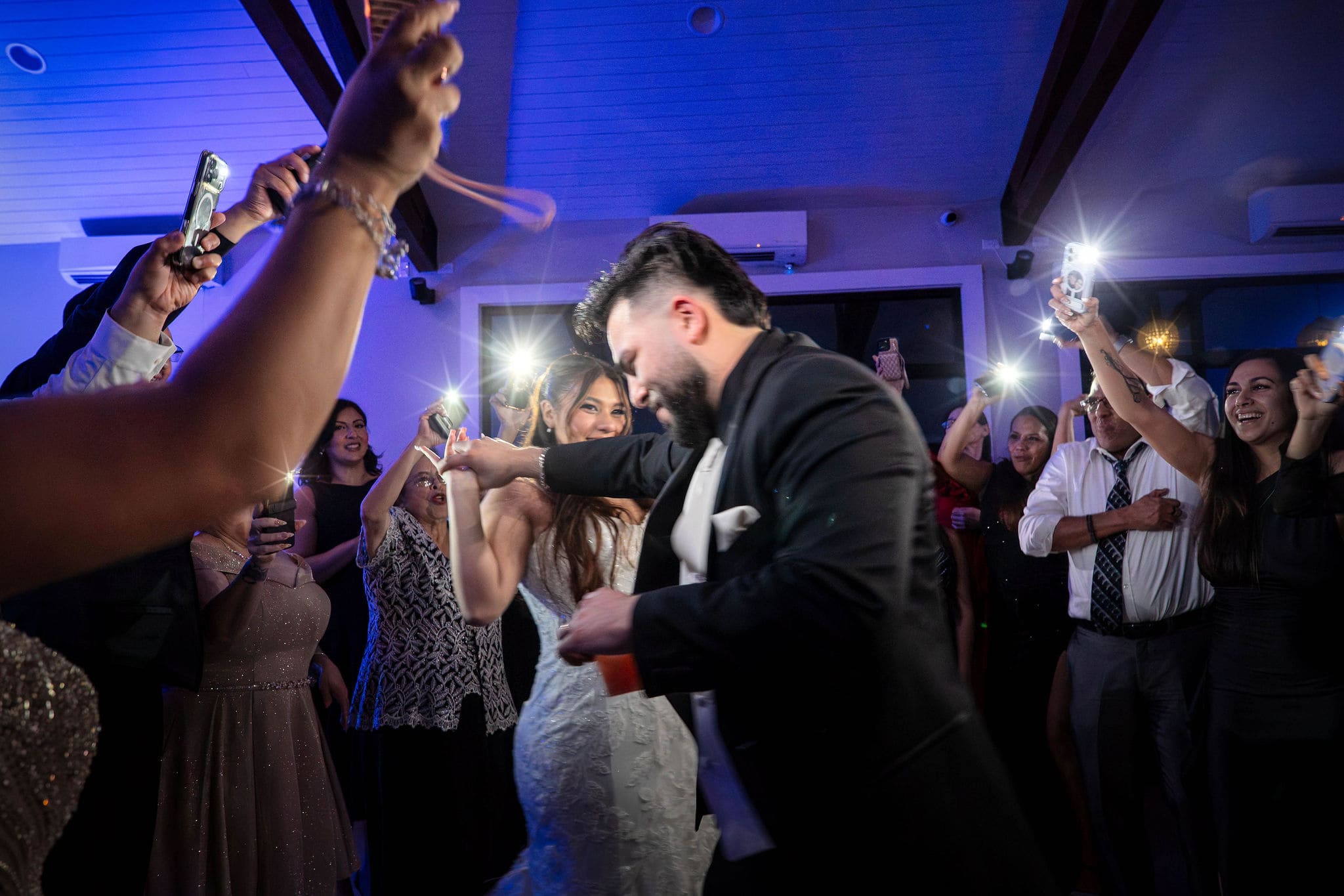 Wedding couple dancing in camera flashes