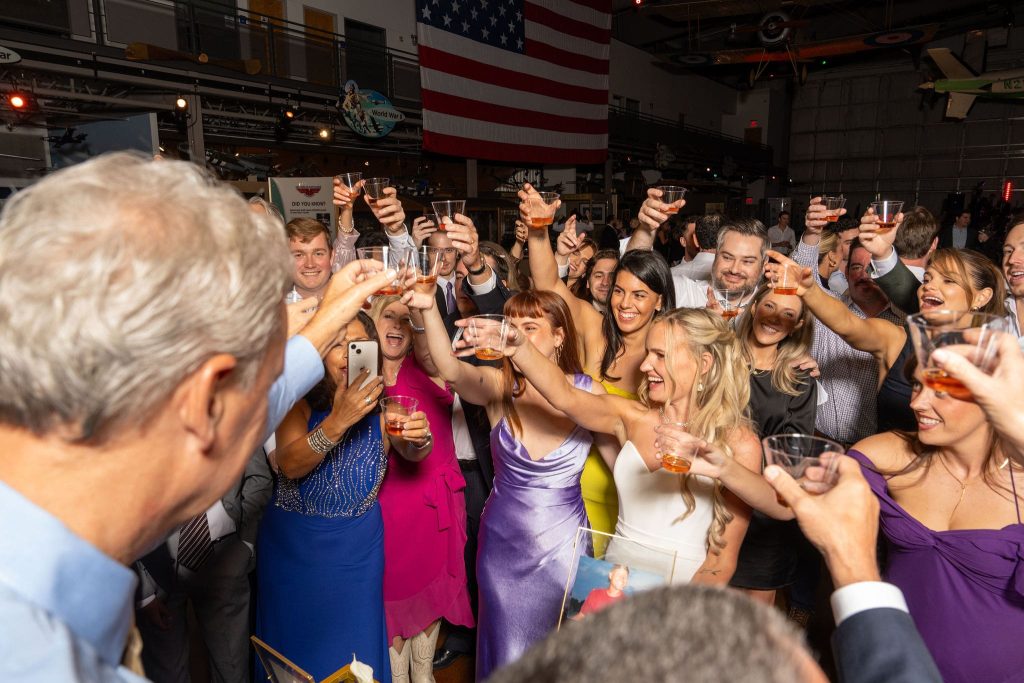 Lots of people toasting at a wedding party