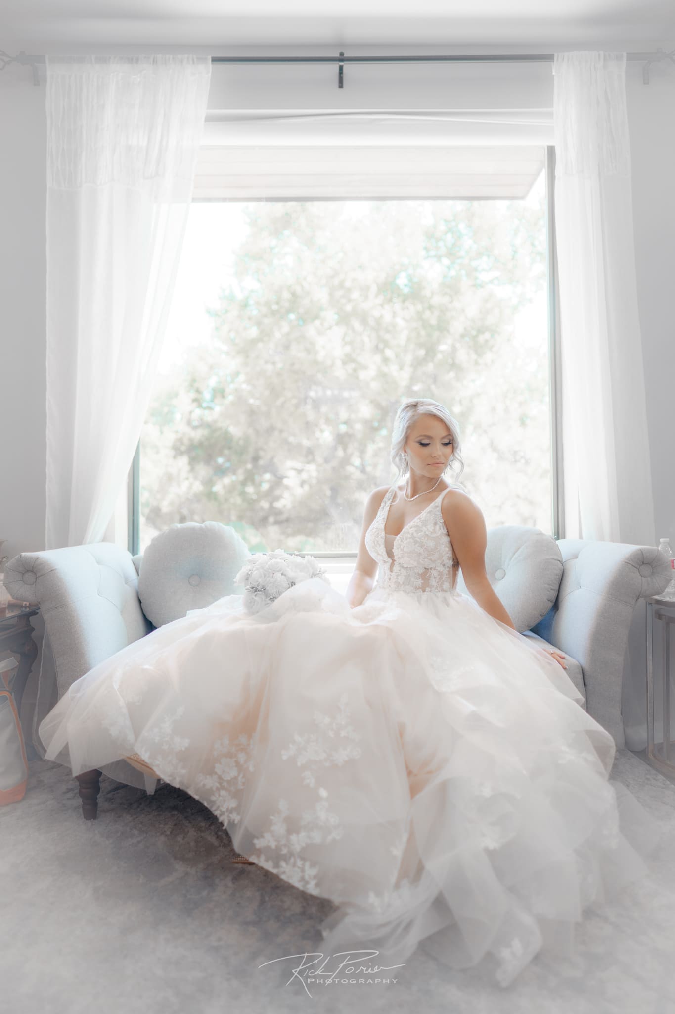 Bride sitting by the window.